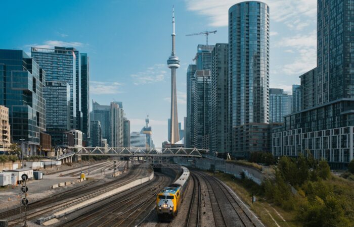 A train traveling through a city with tall buildings