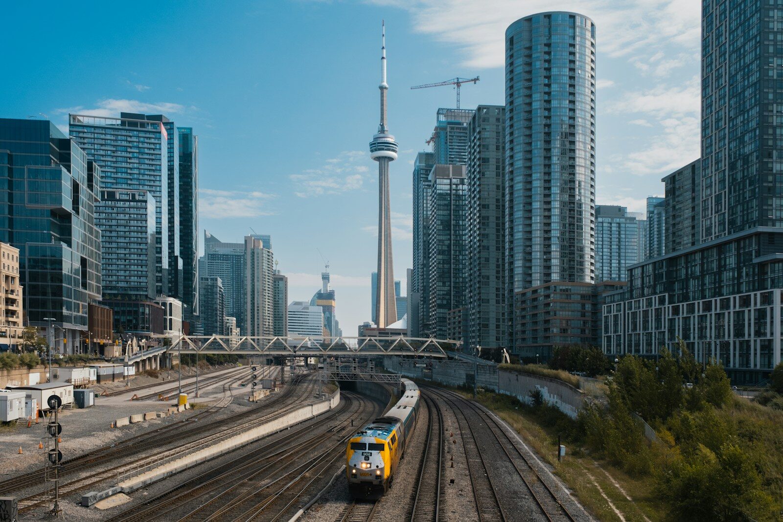 A train traveling through a city with tall buildings
