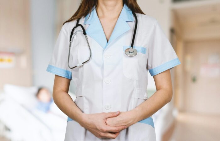 woman in white button up shirt and blue stethoscope