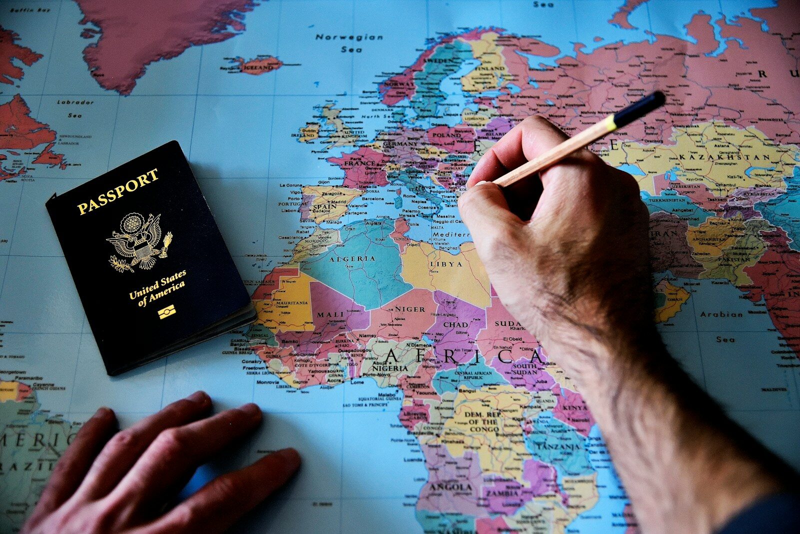 a person is writing on a map with a pencil