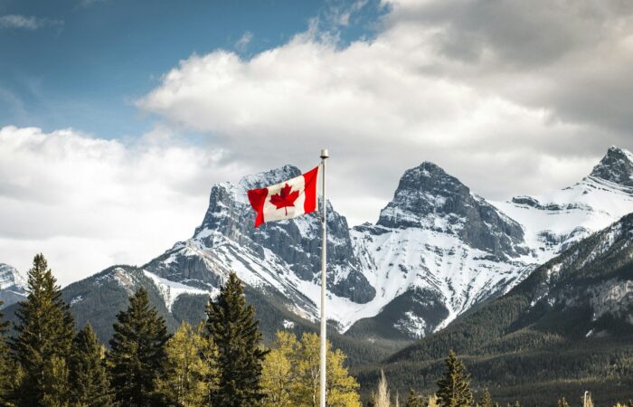 us a flag on pole near snow covered mountain