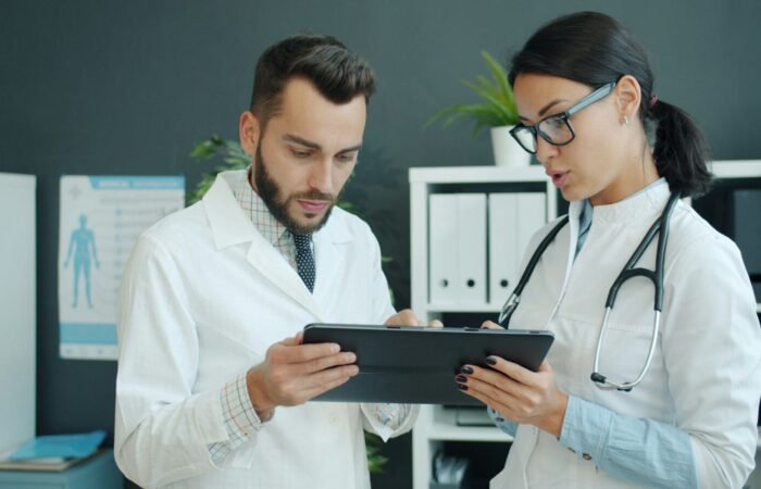 Two doctors looking at a tablet together