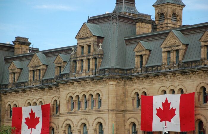Canada flags hanging on concrete castle wall