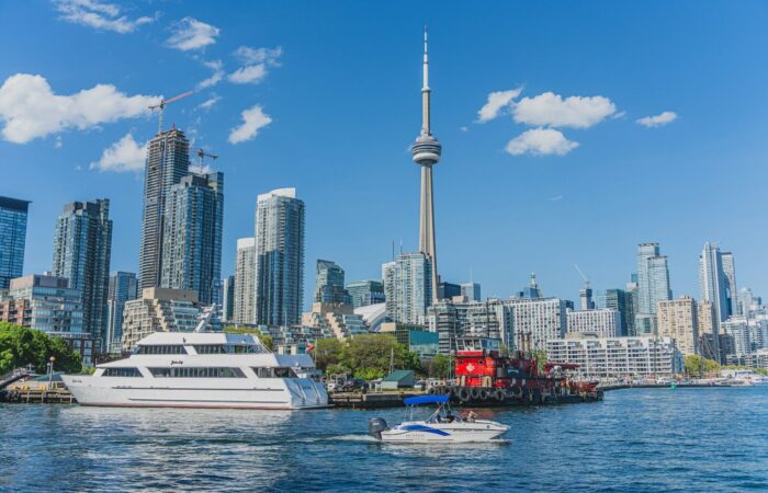 a boat in the water in front of a city