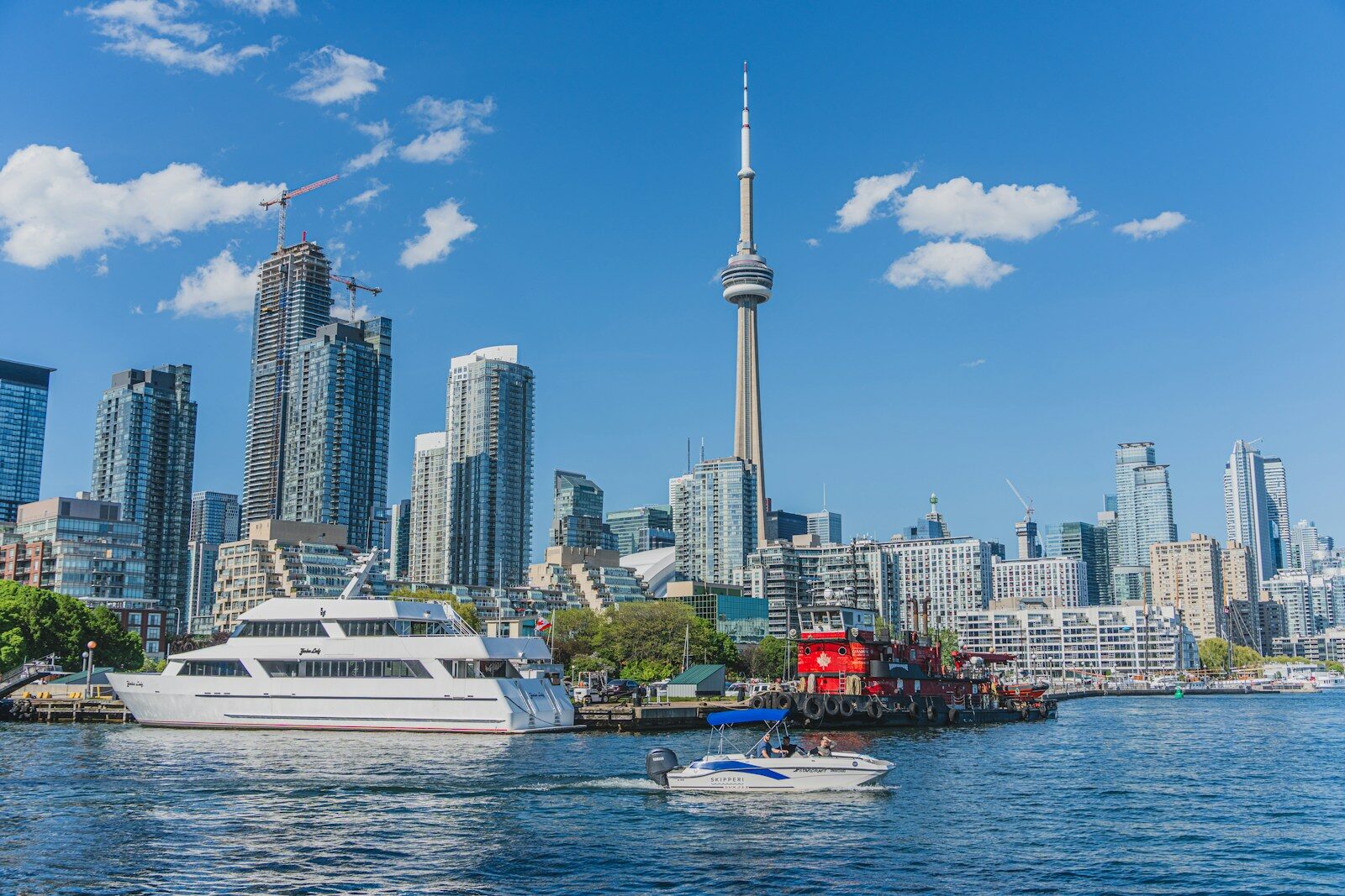 a boat in the water in front of a city